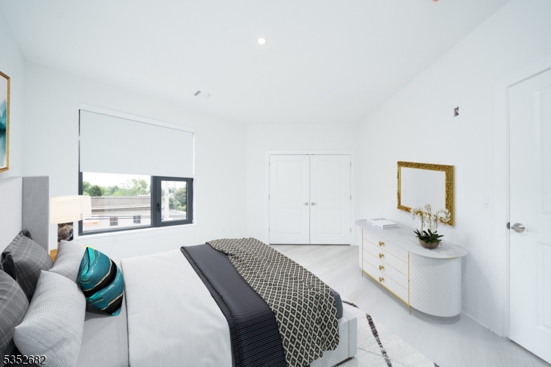 12 River Road, Unit 303 Fair Lawn, NJ 07410 - Photo 8 of 16 a bedroom with a bed and window