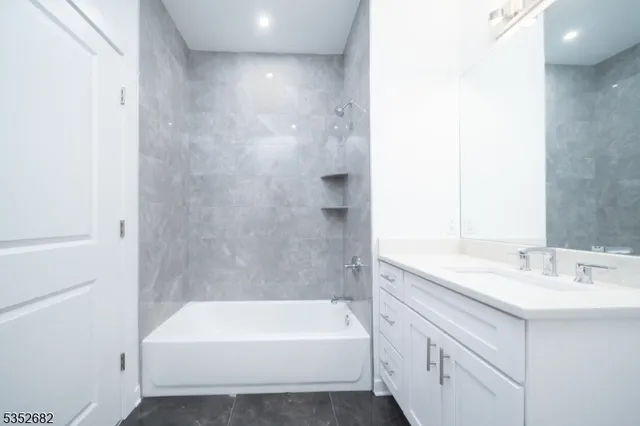 a bathroom with a bathtub and a sink