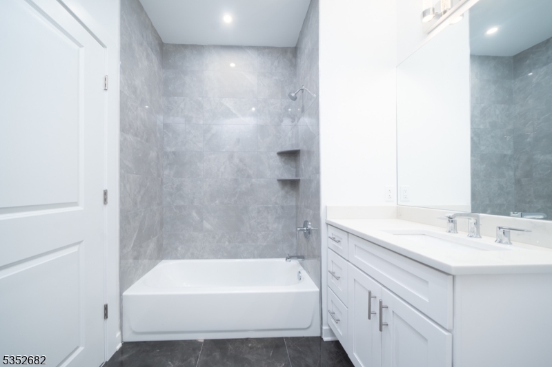 12 River Road, Unit 303 Fair Lawn, NJ 07410 - Photo 9 of 16 a bathroom with a bathtub and a sink