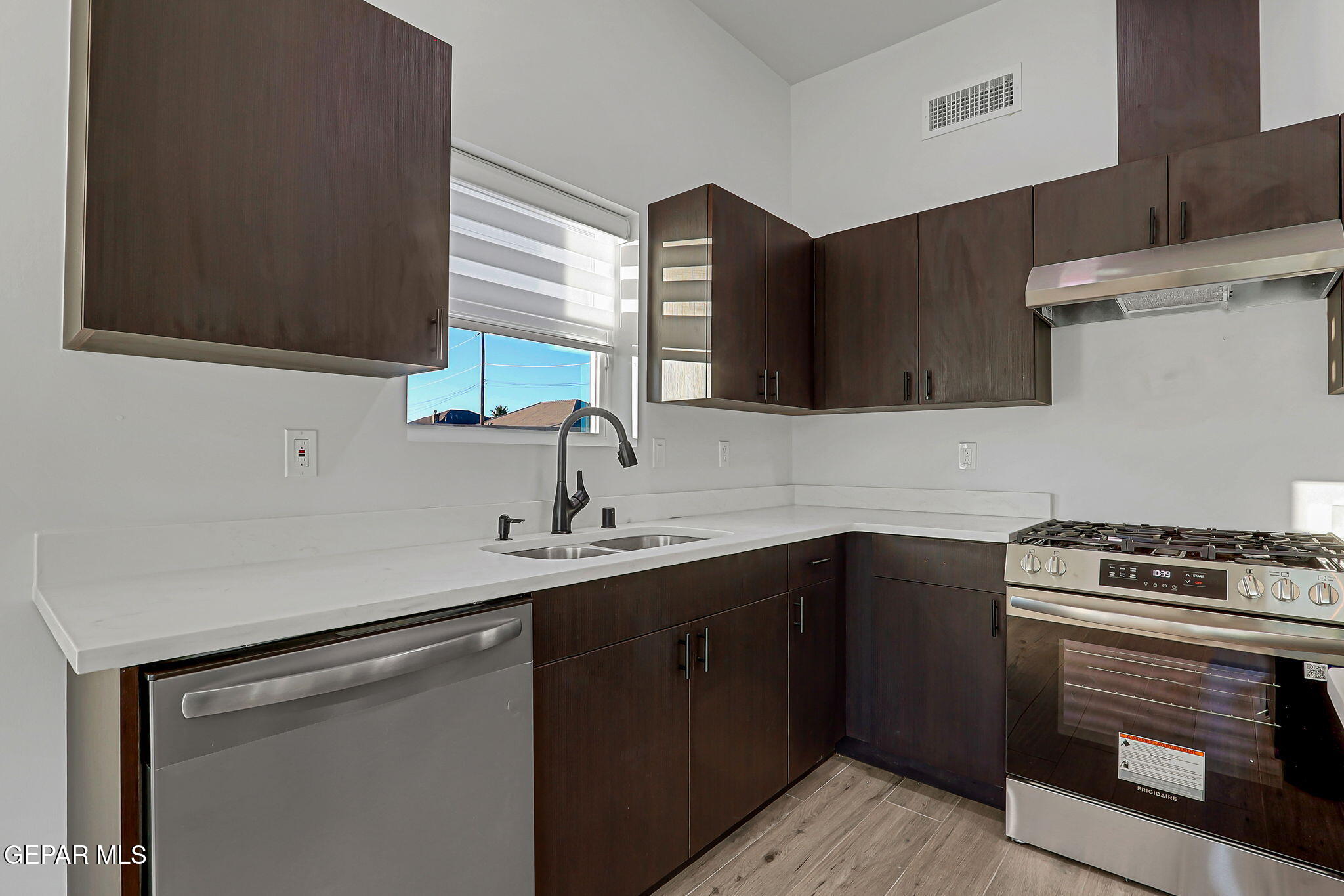5981 Ruidoso Downs Street El Paso, TX 79932 - Photo 12 of 35 a kitchen with a sink stove and cabinets