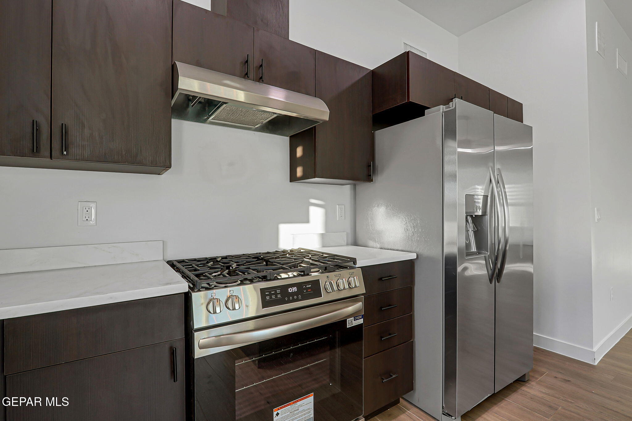 5981 Ruidoso Downs Street El Paso, TX 79932 - Photo 13 of 35 a kitchen with stainless steel appliances granite countertop a stove and a refrigerator