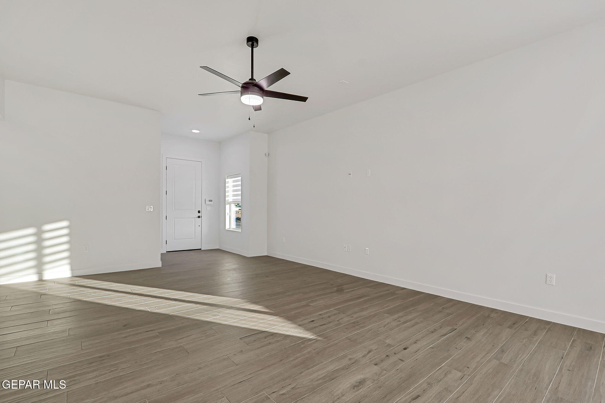 5981 Ruidoso Downs Street El Paso, TX 79932 - Photo 15 of 35 a view of empty room with wooden floor
