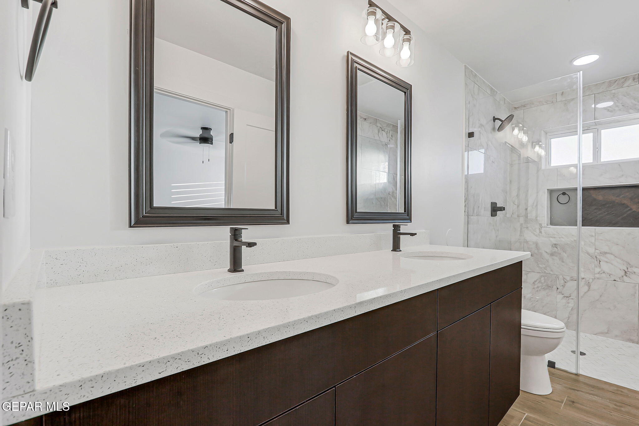 5981 Ruidoso Downs Street El Paso, TX 79932 - Photo 19 of 35 a bathroom with double vanity and a mirror