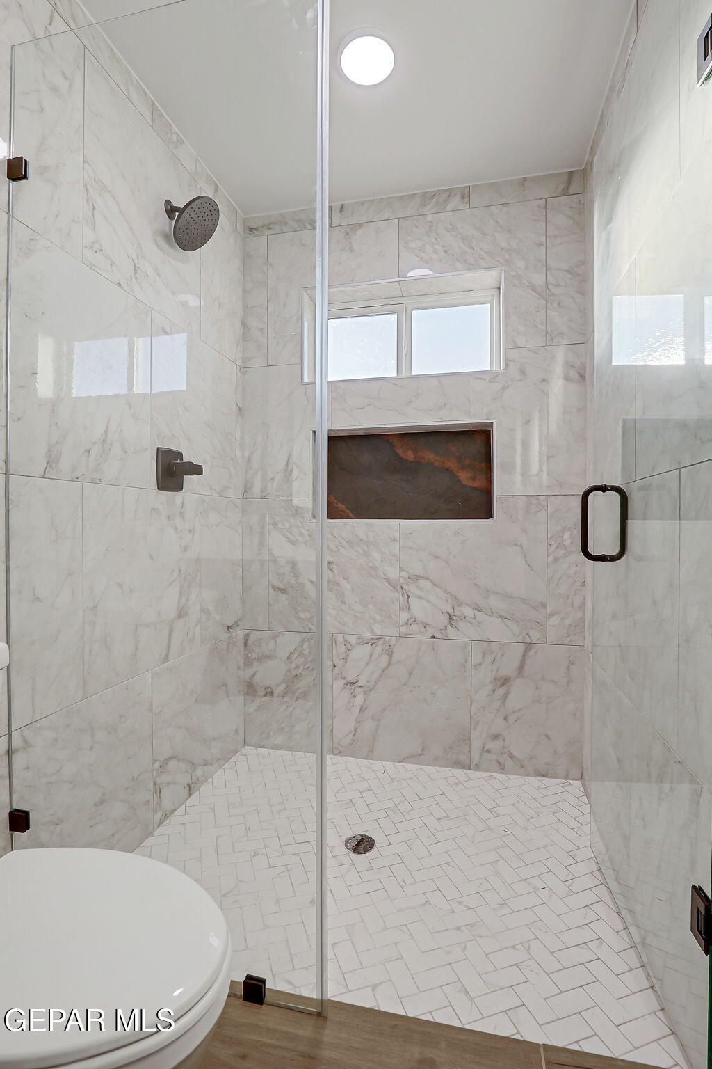 5981 Ruidoso Downs Street El Paso, TX 79932 - Photo 20 of 35 a bathroom with a toilet and shower