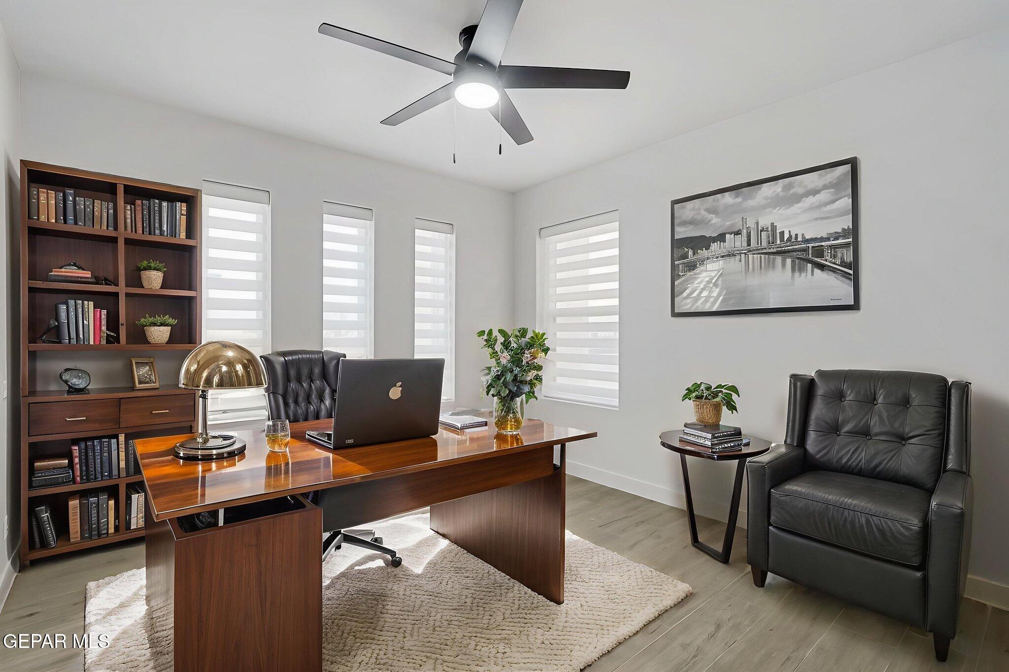 5981 Ruidoso Downs Street El Paso, TX 79932 - Photo 23 of 35 a view of a livingroom with workspace and a couch