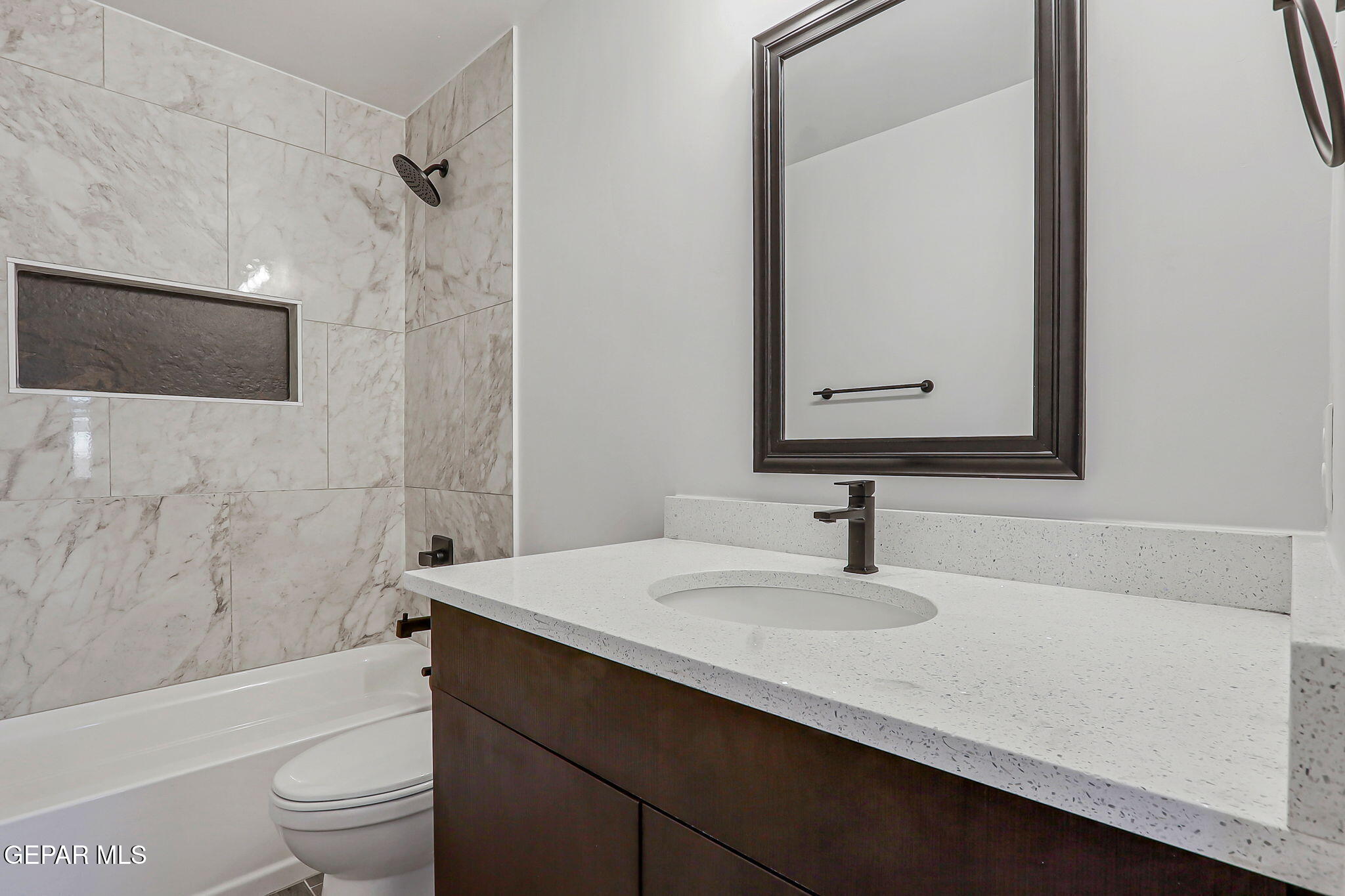 5981 Ruidoso Downs Street El Paso, TX 79932 - Photo 25 of 35 a bathroom with a sink a toilet a mirror and shower