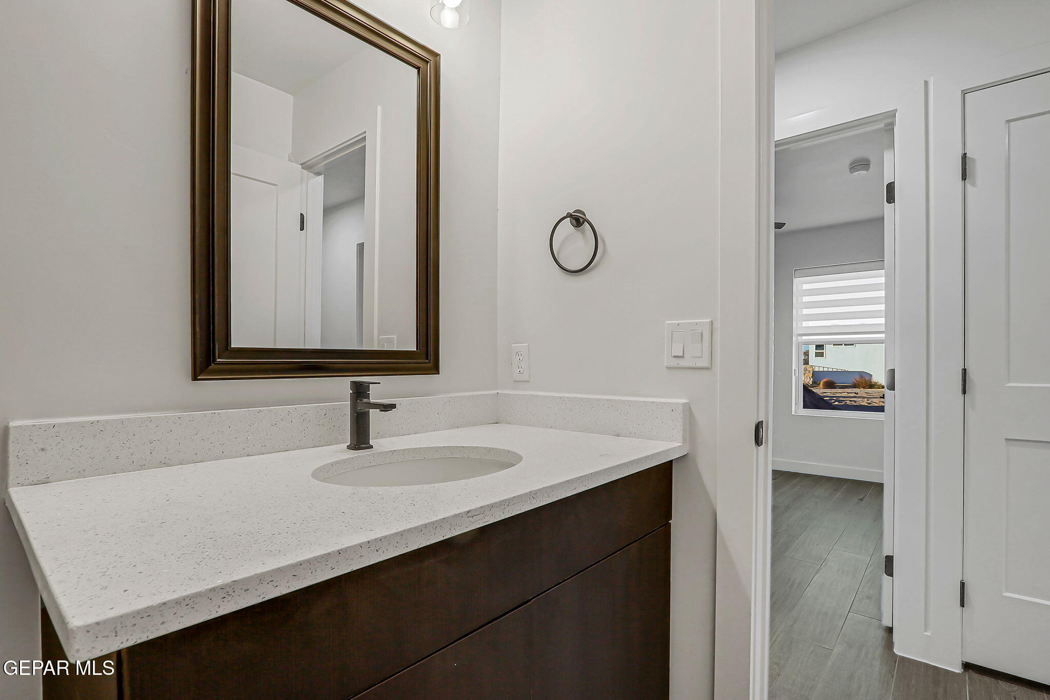 5981 Ruidoso Downs Street El Paso, TX 79932 - Photo 26 of 35 a bathroom with a sink and a mirror
