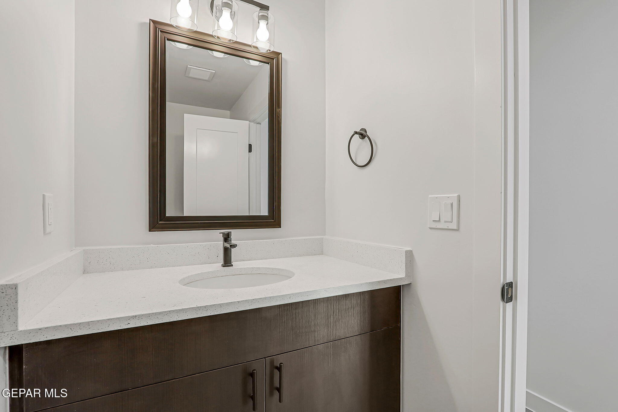 5981 Ruidoso Downs Street El Paso, TX 79932 - Photo 31 of 35 a bathroom with a sink and a mirror