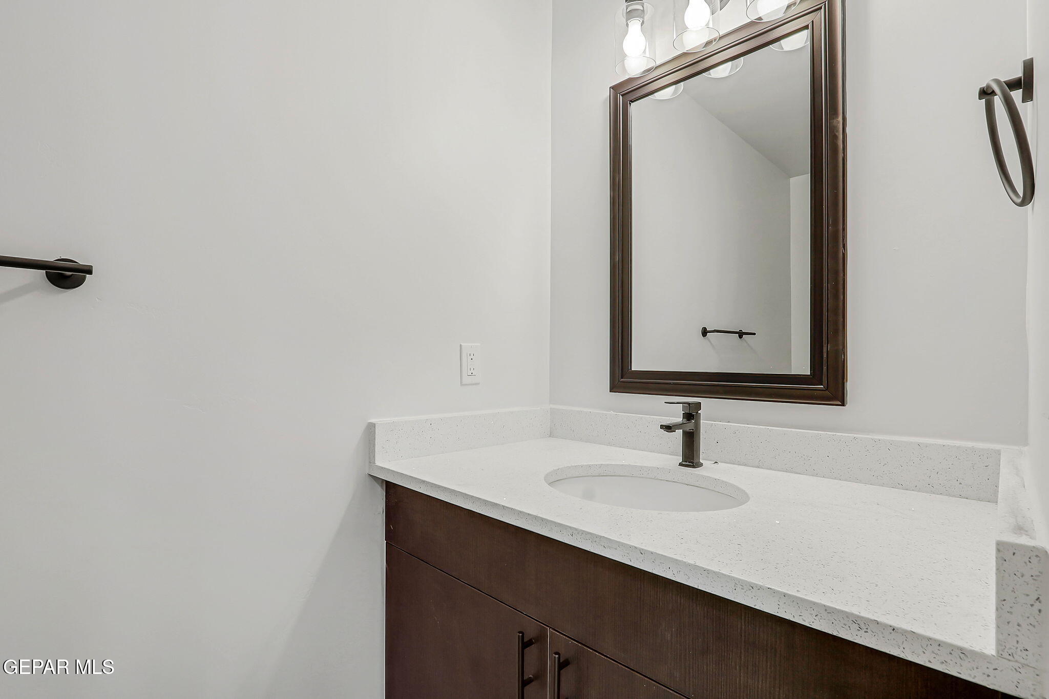 5981 Ruidoso Downs Street El Paso, TX 79932 - Photo 32 of 35 a bathroom with a sink and a mirror