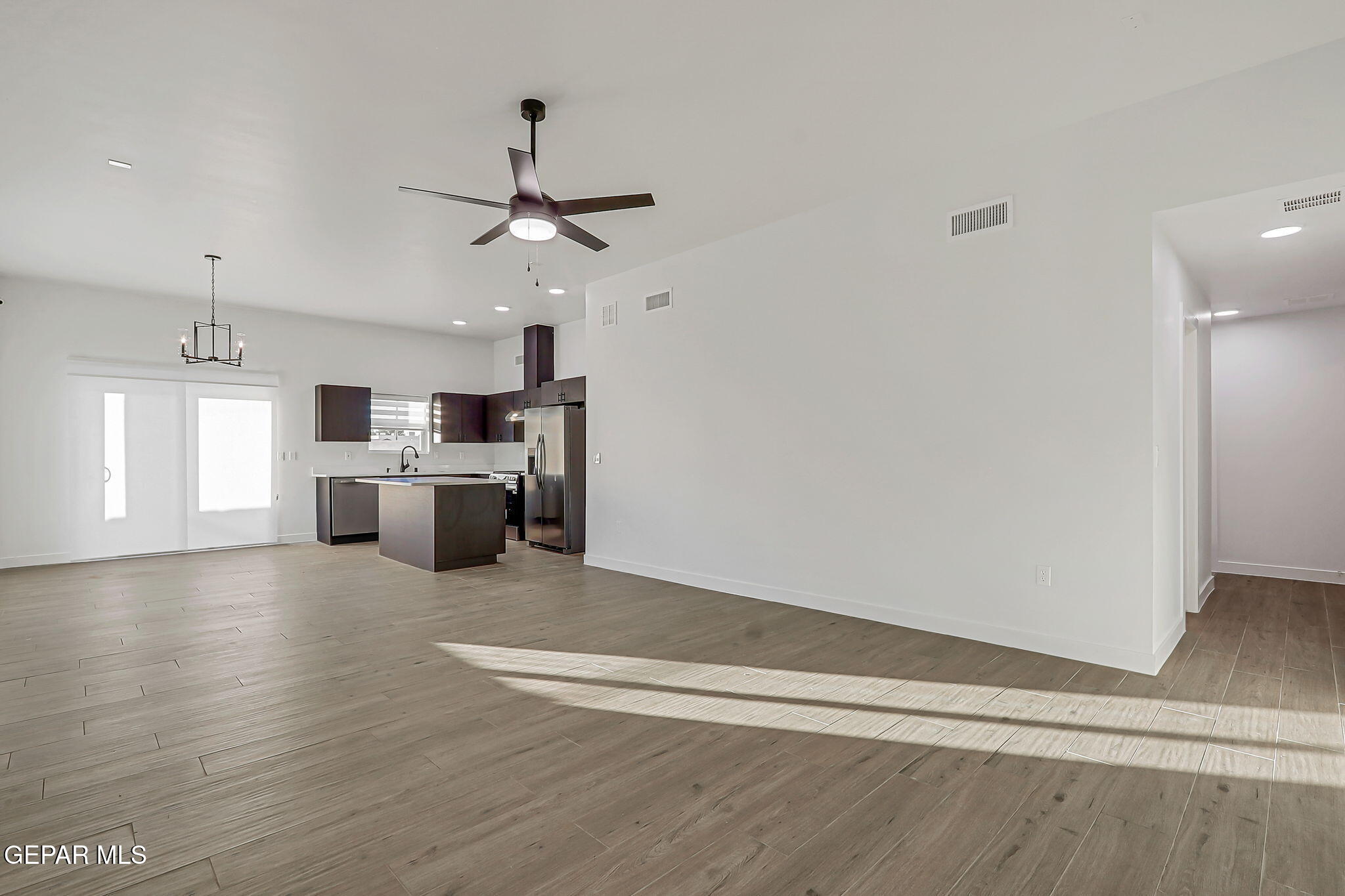 5981 Ruidoso Downs Street El Paso, TX 79932 - Photo 5 of 35 a view of kitchen with wooden floor electronic appliances and window