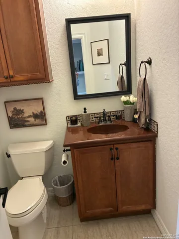 a bathroom with a toilet a sink and mirror