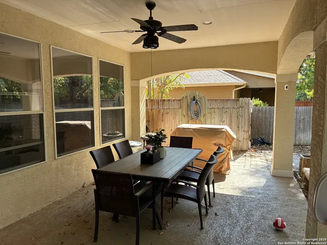 a dining room with furniture a chandelier and window