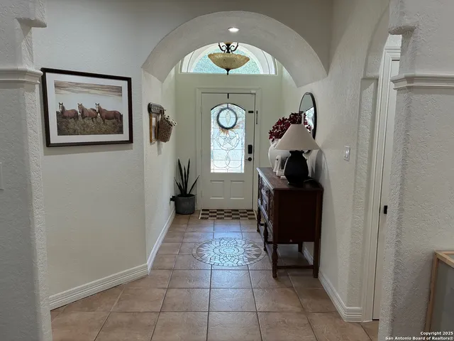 a view of entryway with a front door and wooden floor