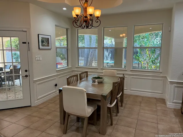 a dining room with furniture and window