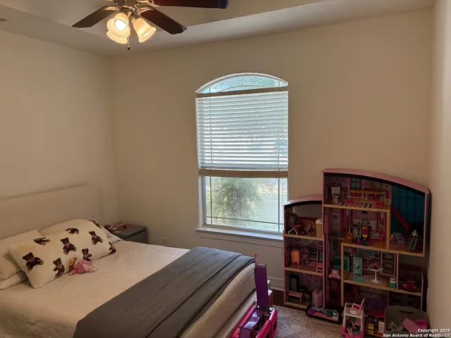 a bedroom with a bed and a book shelf