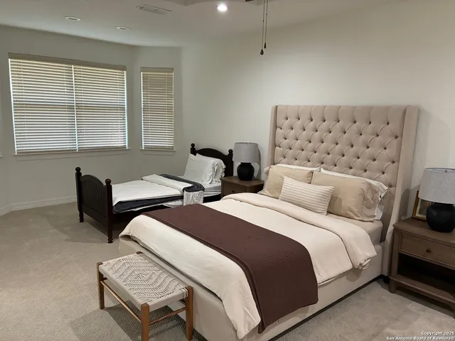 a bedroom with two beds and a window