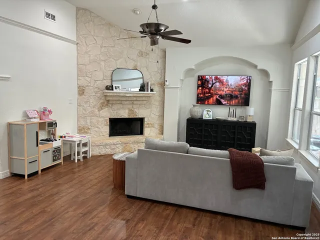 a living room with furniture fireplace and flat screen tv
