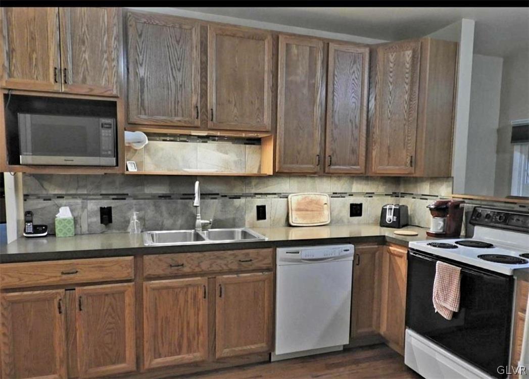 3110 Fern Road Pocono Summit, PA 18346 - Photo 6 of 20 a kitchen with stainless steel appliances granite countertop a sink a stove and cabinets