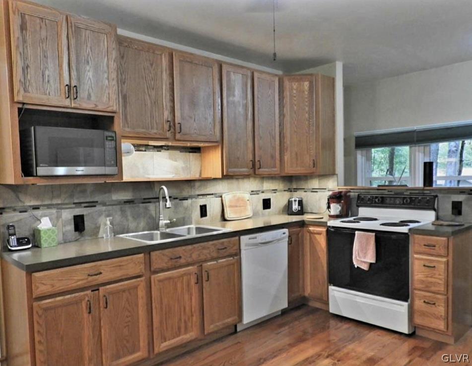 3110 Fern Road Pocono Summit, PA 18346 - Photo 7 of 20 a kitchen with stainless steel appliances granite countertop a stove a sink dishwasher and a microwave oven with cabinets