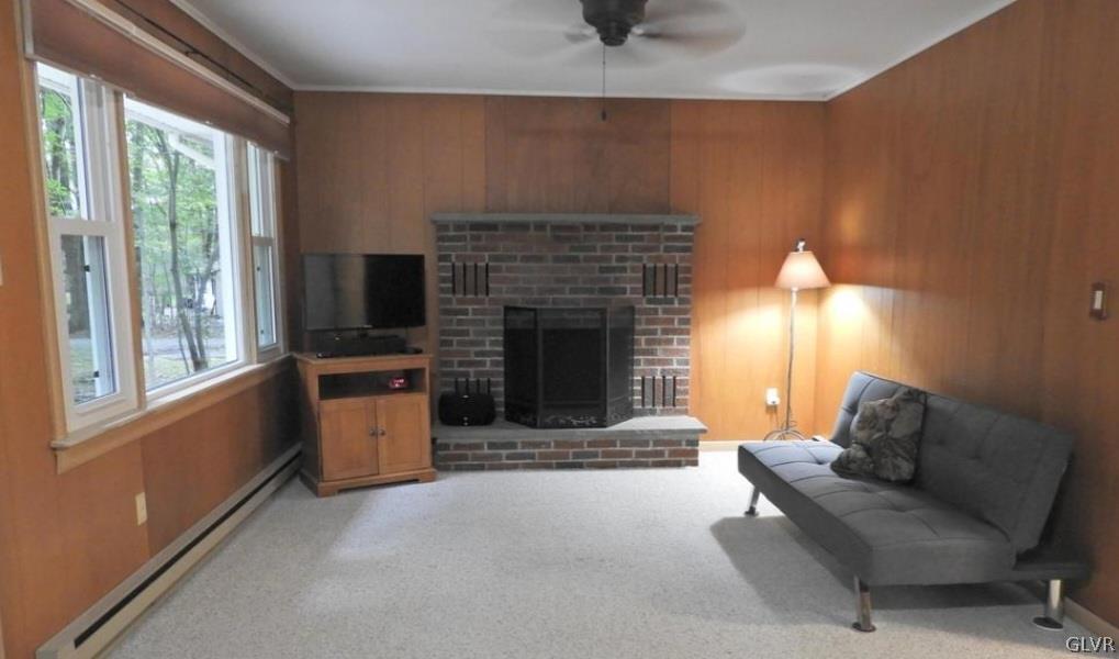 3110 Fern Road Pocono Summit, PA 18346 - Photo 8 of 20 a living room with furniture and a fireplace