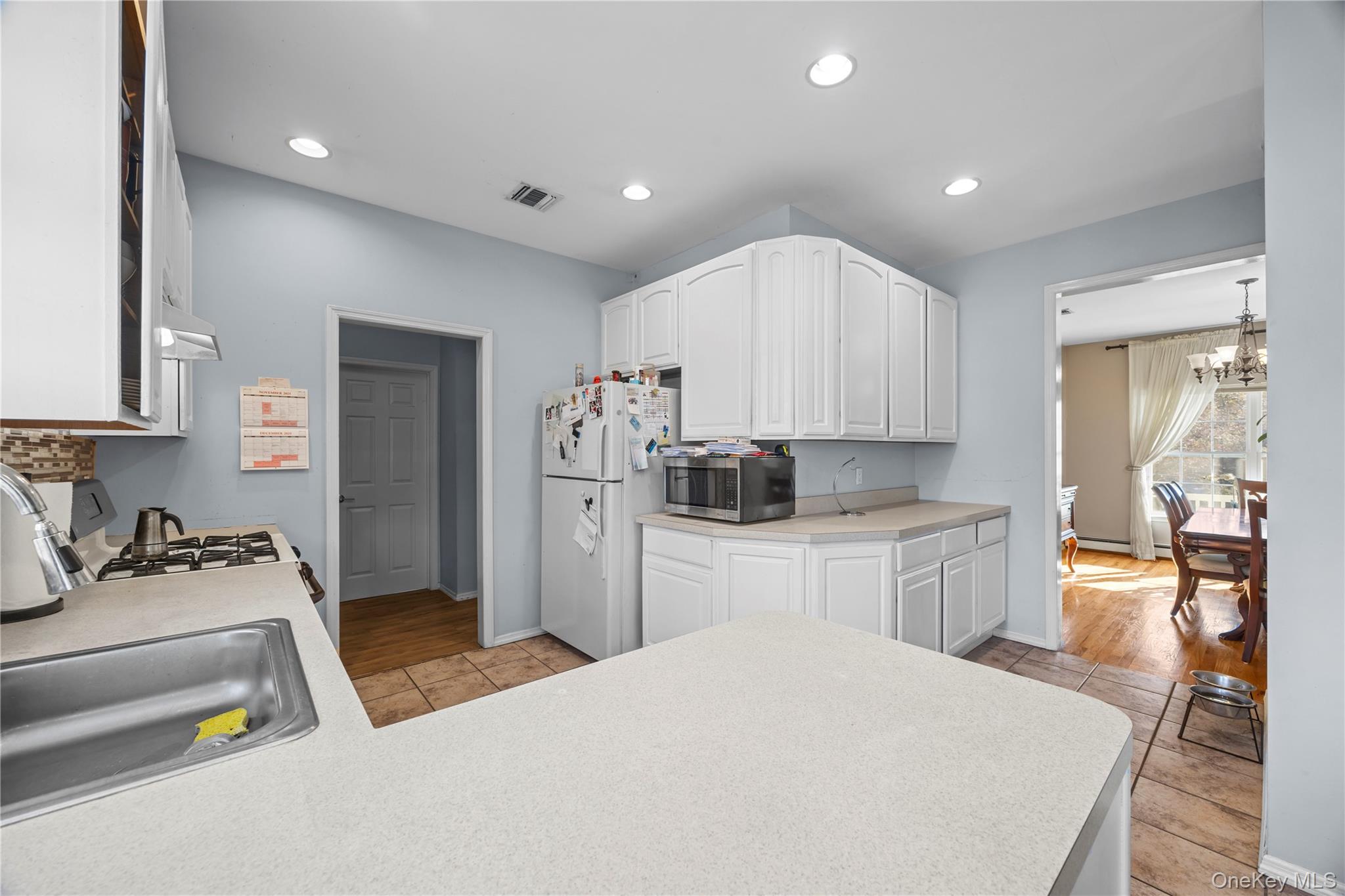 7 Bittersweet Lane Center Moriches, NY 11934 - Photo 12 of 32 a kitchen that has a lot of cabinets a sink and appliances in it