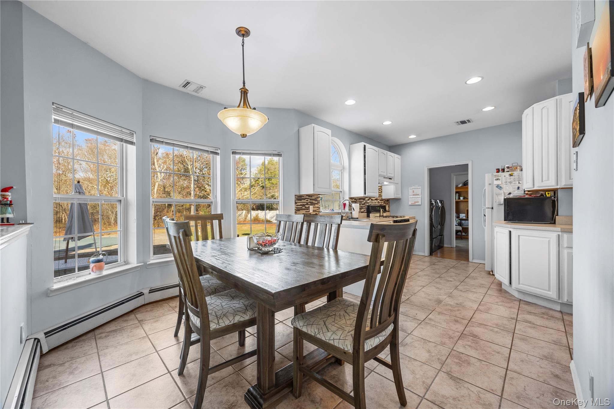7 Bittersweet Lane Center Moriches, NY 11934 - Photo 13 of 32 a view of a dining room with furniture window and outside view