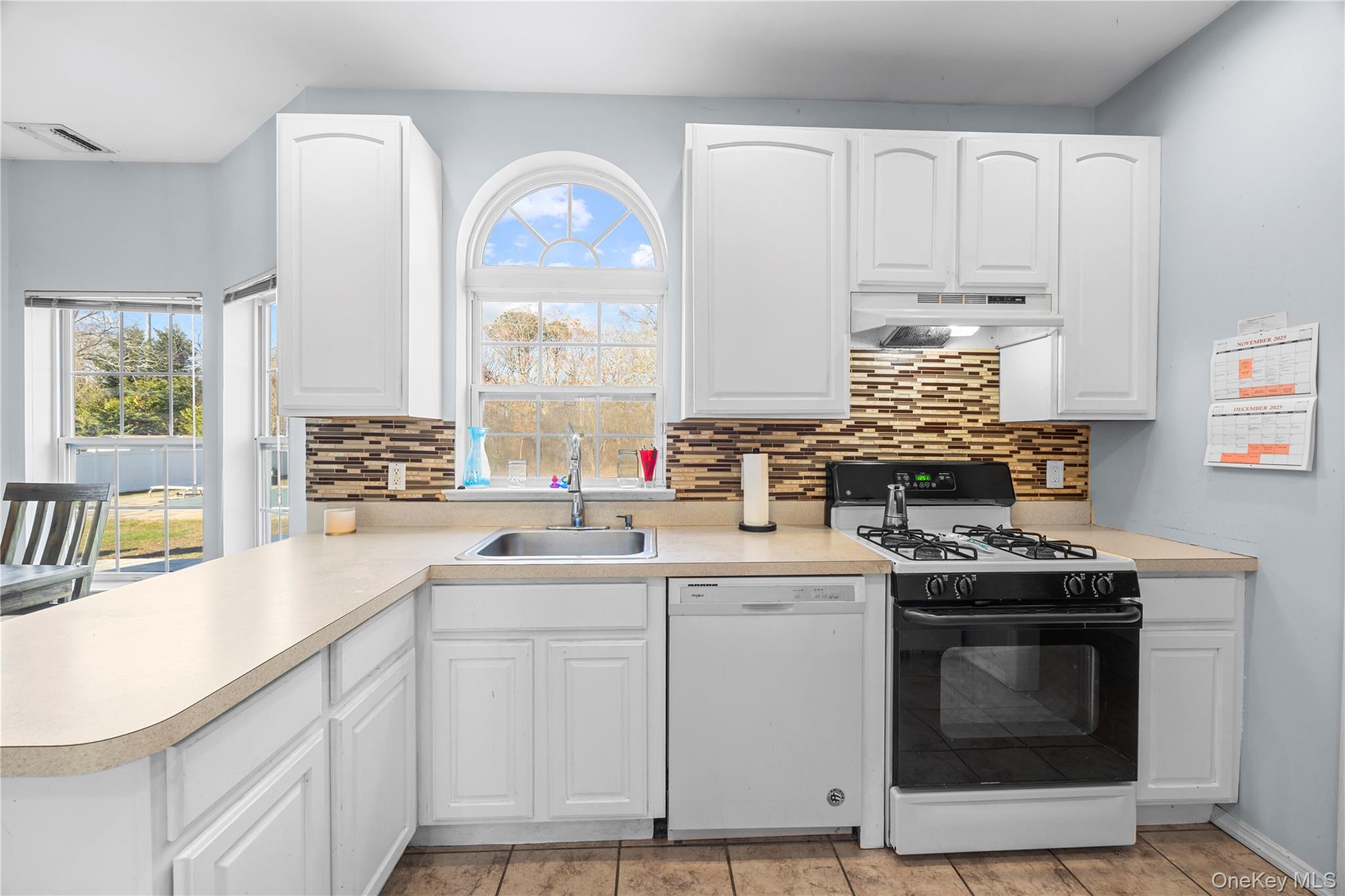 7 Bittersweet Lane Center Moriches, NY 11934 - Photo 15 of 32 a kitchen with cabinets appliances a sink and a window