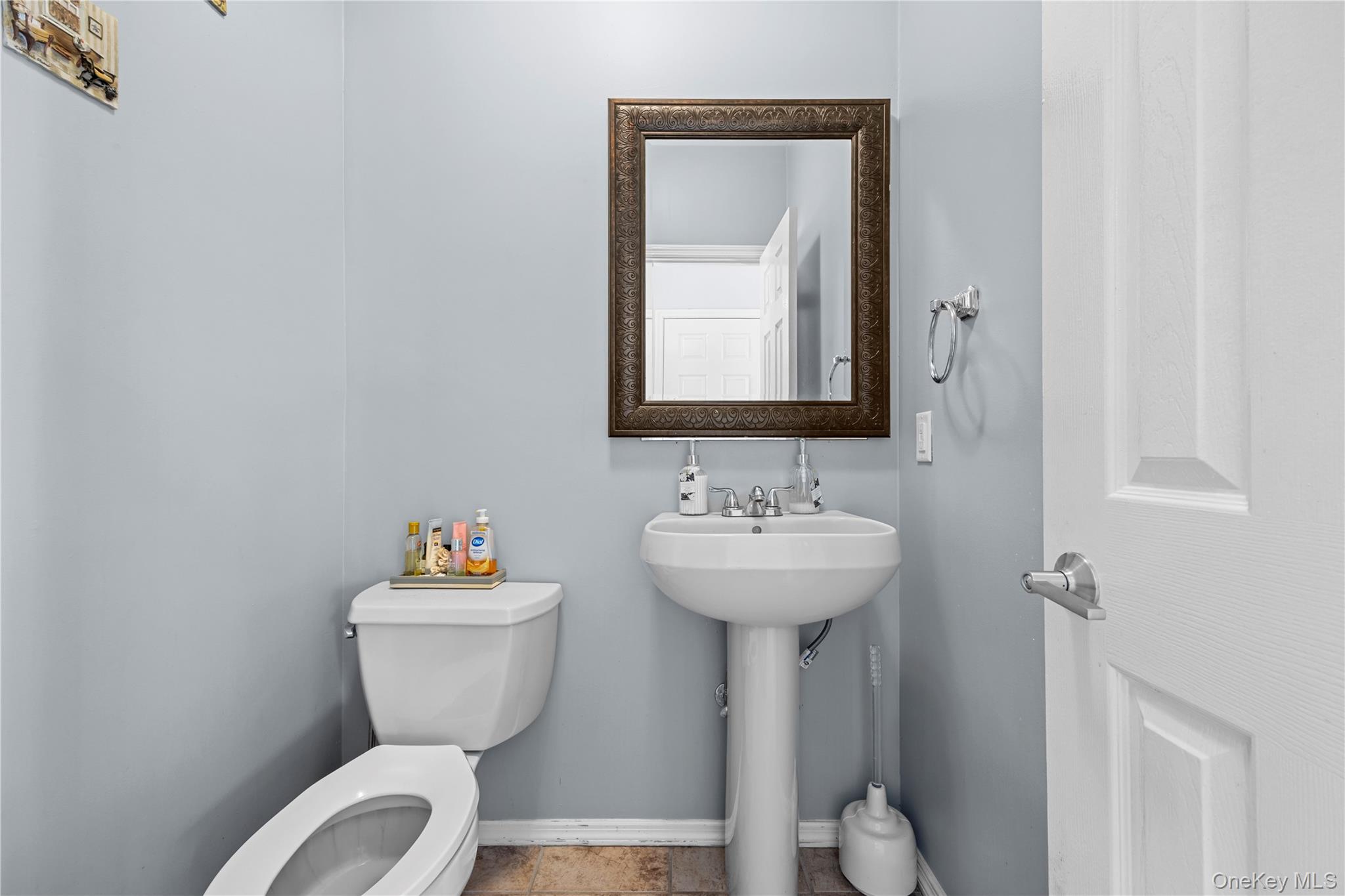 7 Bittersweet Lane Center Moriches, NY 11934 - Photo 18 of 32 a bathroom with a toilet sink and mirror