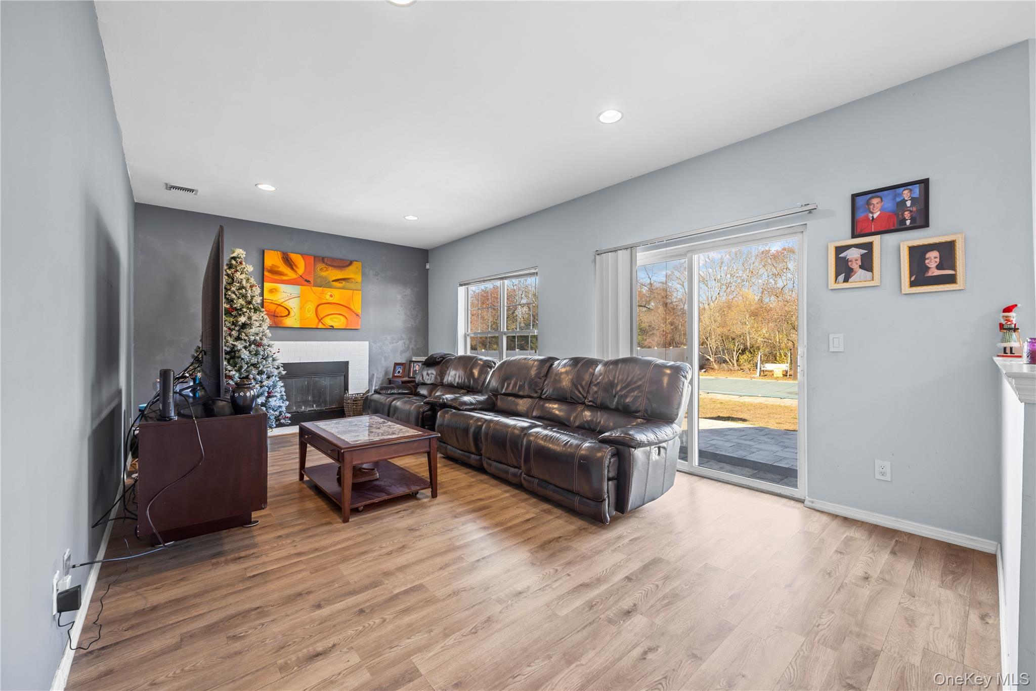 7 Bittersweet Lane Center Moriches, NY 11934 - Photo 19 of 32 a living room with furniture and a flat screen tv