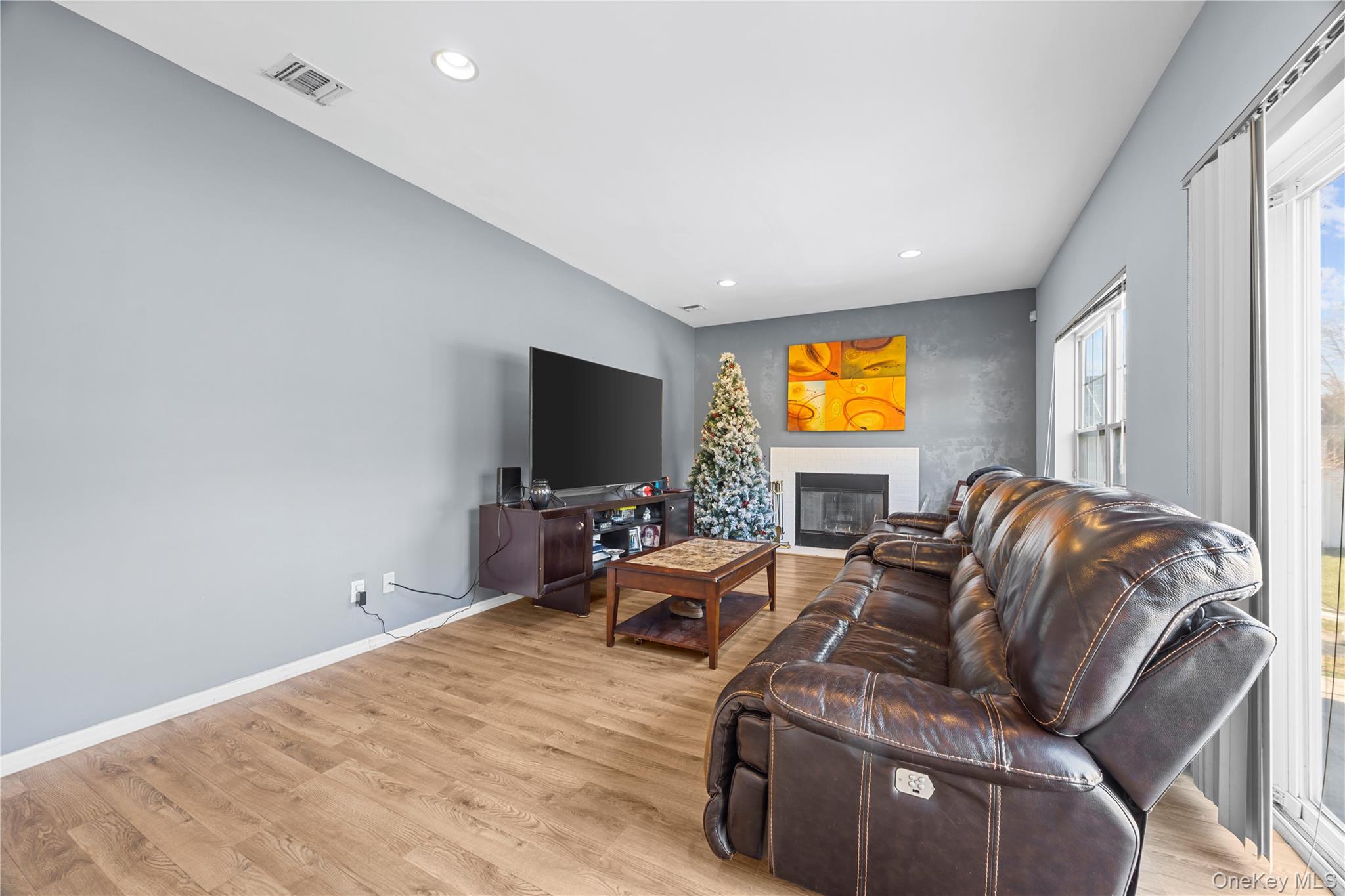 7 Bittersweet Lane Center Moriches, NY 11934 - Photo 20 of 32 a living room with furniture and a flat screen tv