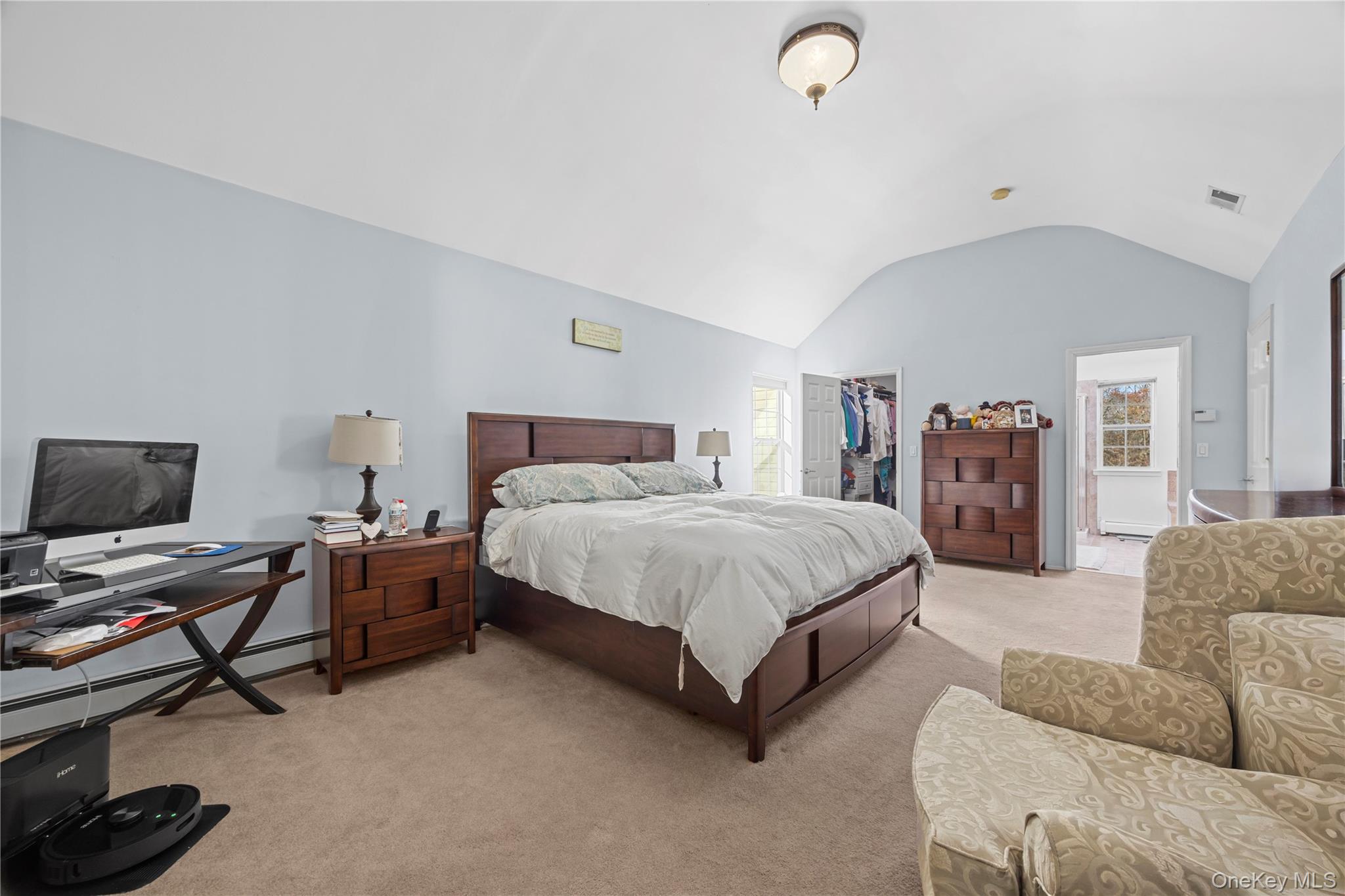 7 Bittersweet Lane Center Moriches, NY 11934 - Photo 21 of 32 a spacious bedroom with a bed and gym equipment