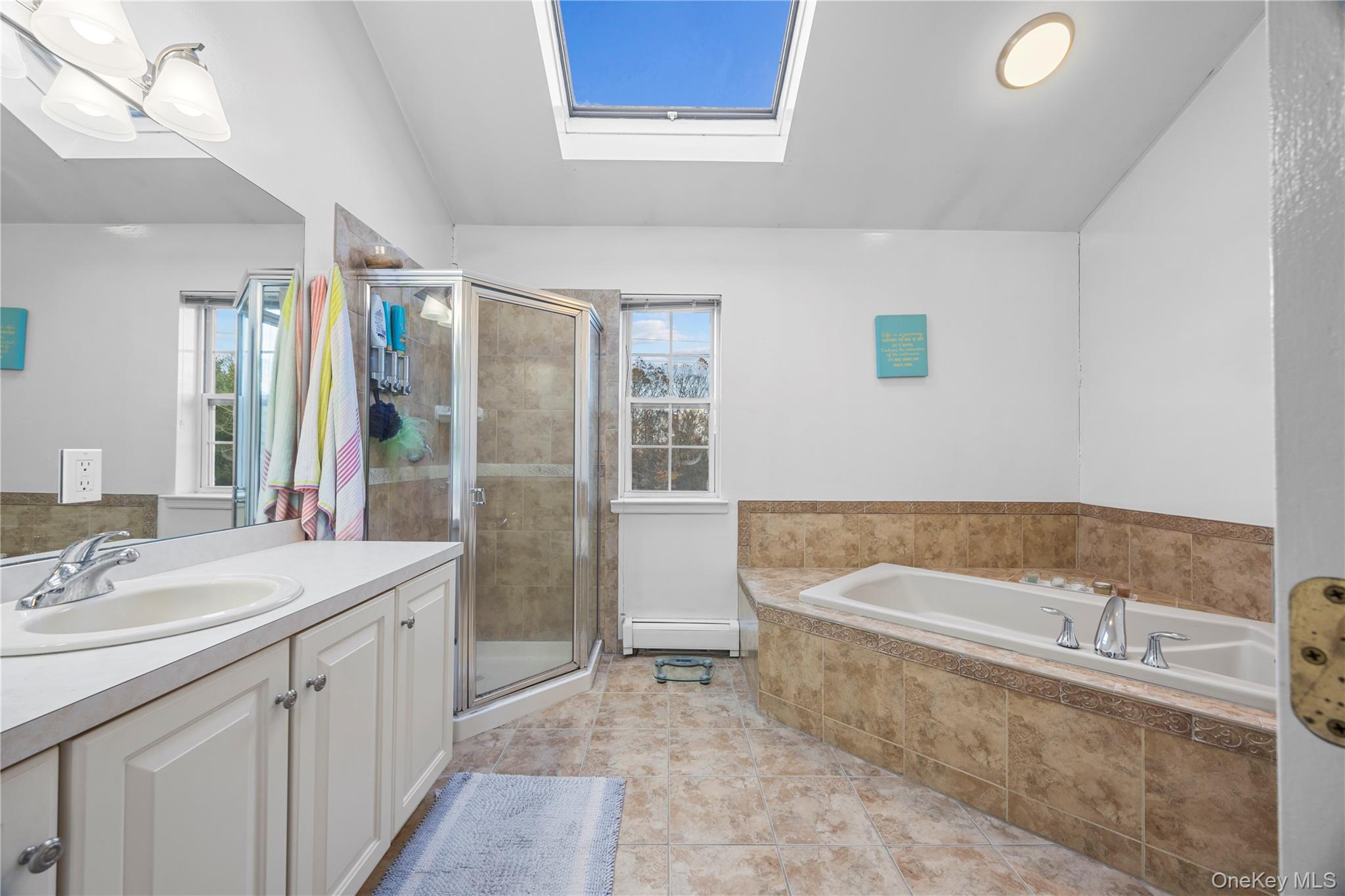 7 Bittersweet Lane Center Moriches, NY 11934 - Photo 23 of 32 a bathroom with a tub sink and mirror