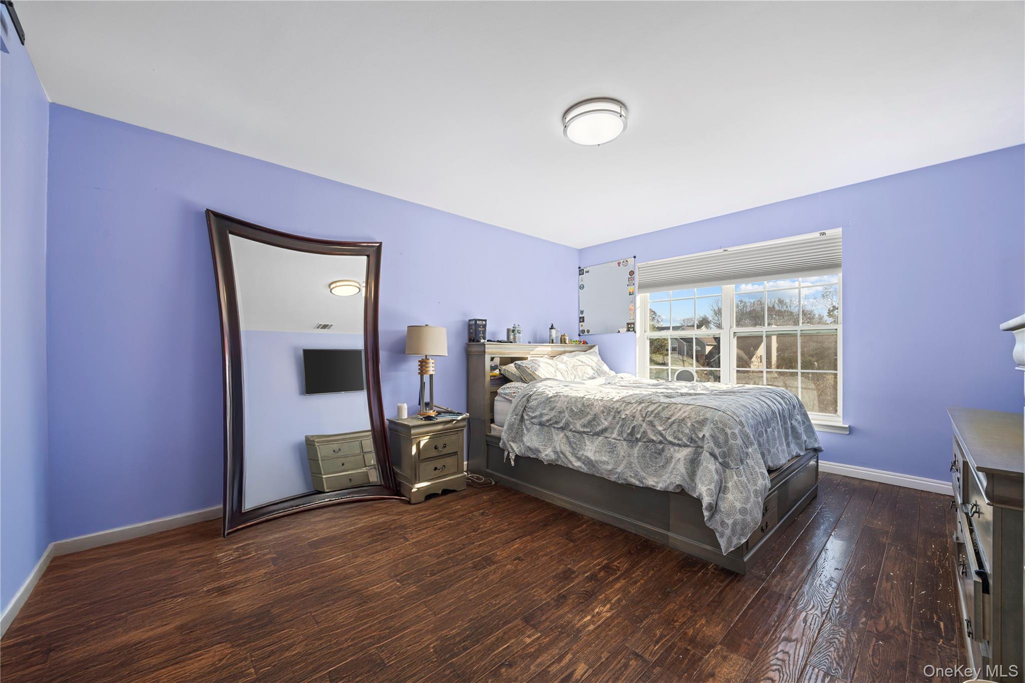 7 Bittersweet Lane Center Moriches, NY 11934 - Photo 26 of 32 a bedroom with a bed and wooden floor