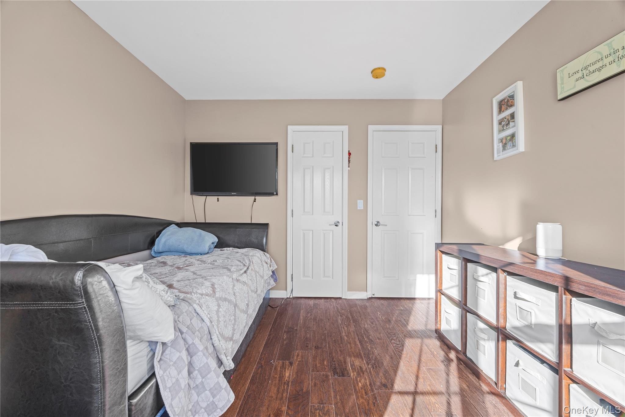 7 Bittersweet Lane Center Moriches, NY 11934 - Photo 30 of 32 a bedroom with a bed and a flat screen tv