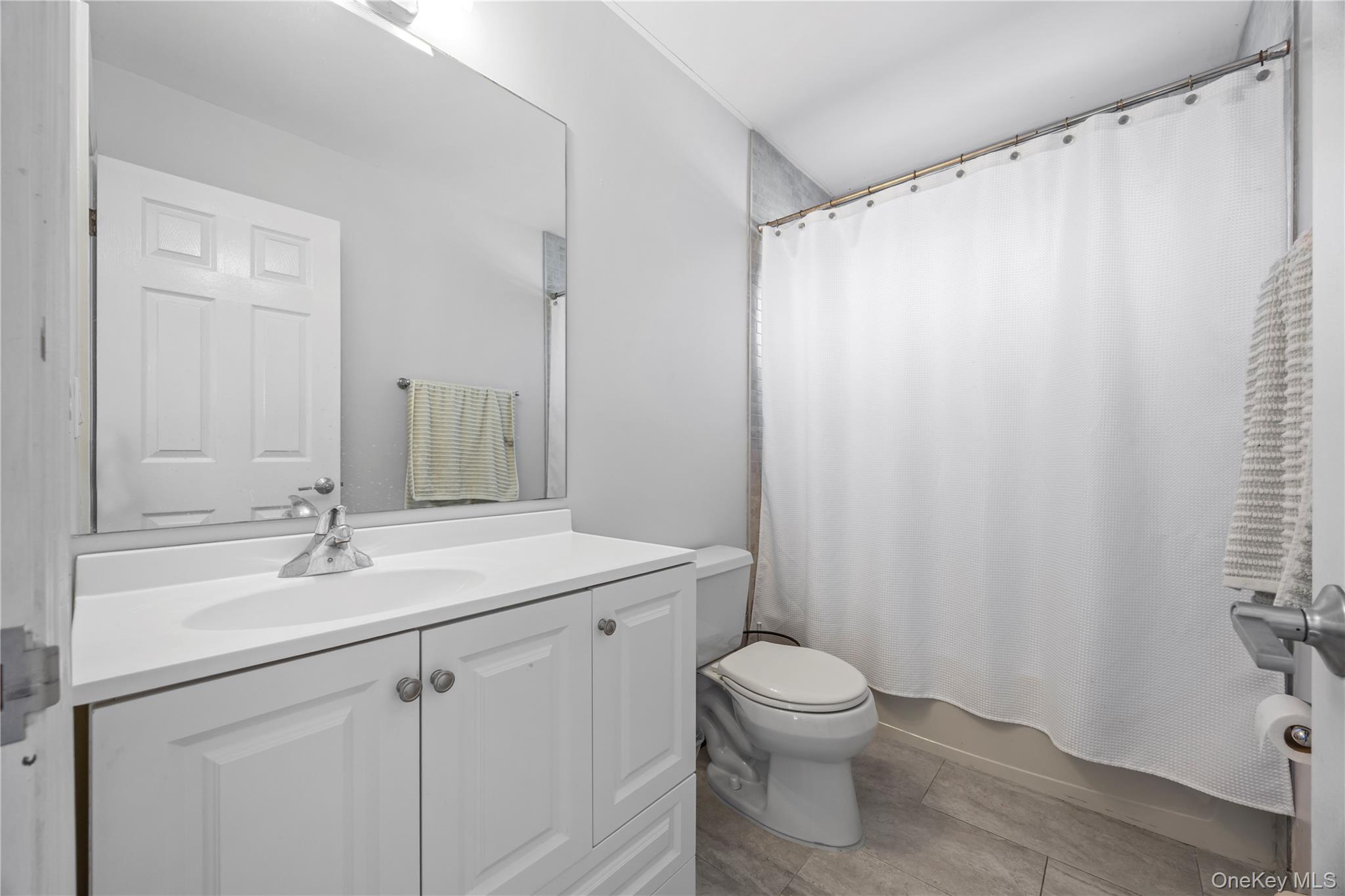 7 Bittersweet Lane Center Moriches, NY 11934 - Photo 31 of 32 a bathroom with a granite countertop sink toilet and shower