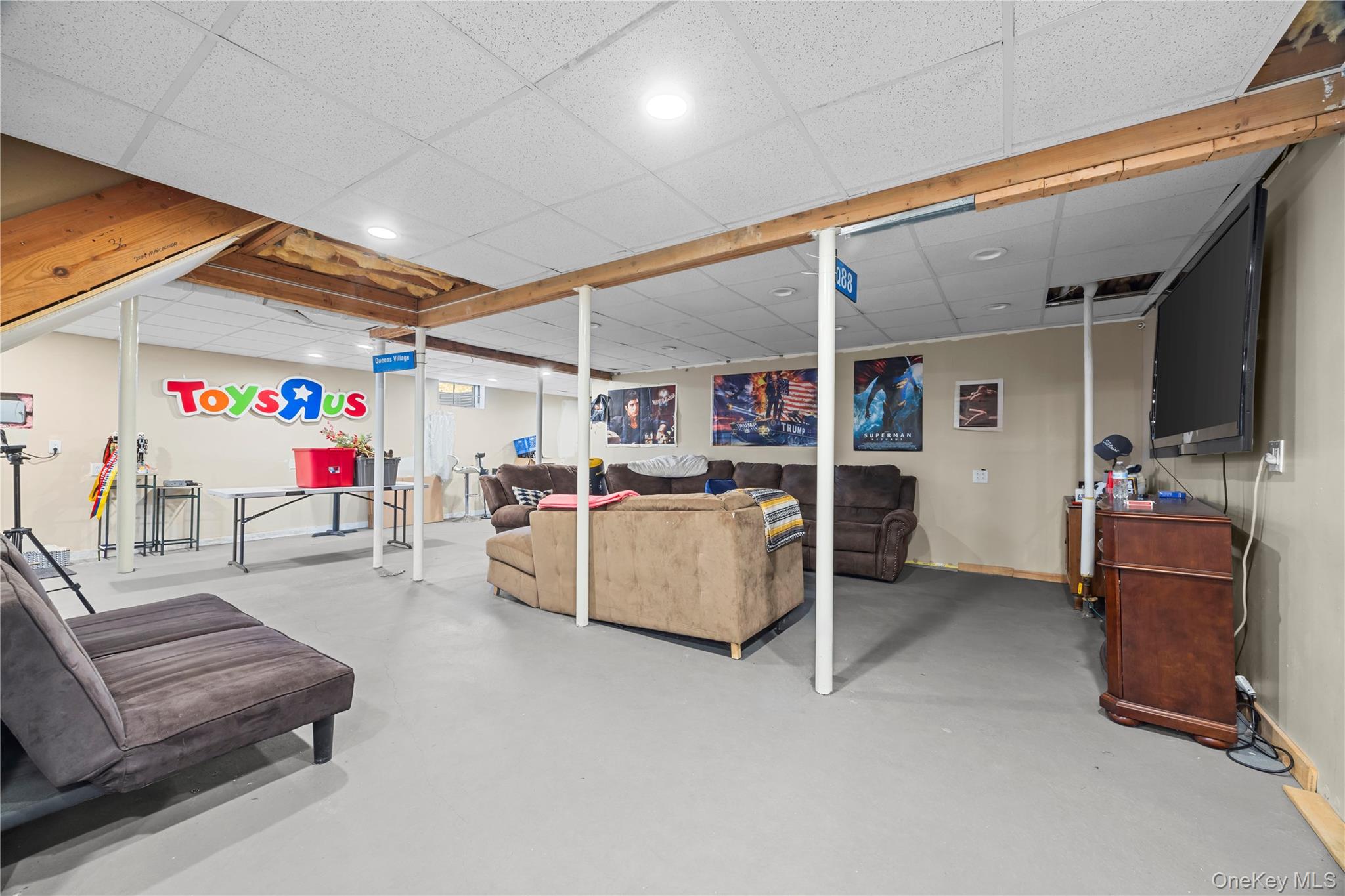 7 Bittersweet Lane Center Moriches, NY 11934 - Photo 32 of 32 a living room with furniture and a flat screen tv