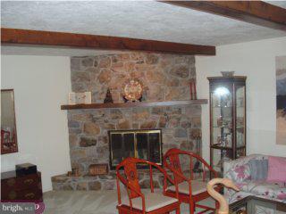 712 Fulmer Road Pottstown, PA 19465 - Photo 5 of 6 a living room with furniture and a fireplace