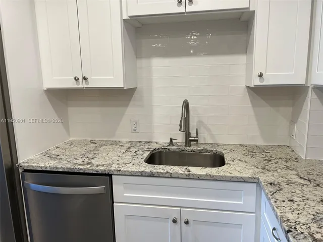 a kitchen with granite countertop white cabinets and a granite counter tops
