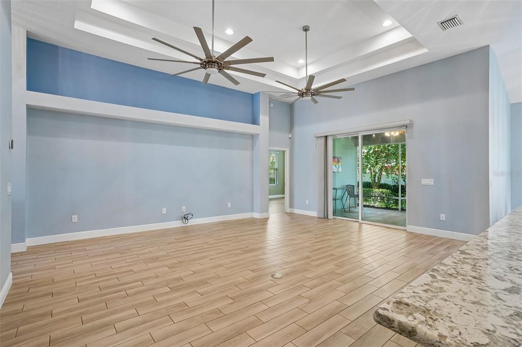 10339 Addison Shore Way Oxford, FL 34484 - Photo 27 of 54 a view of an empty room with a window and wooden floor