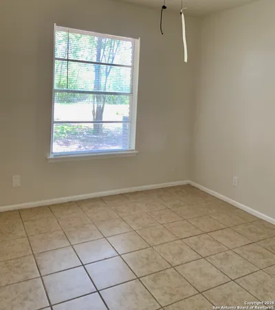 a bathroom with a granite countertop sink a large mirror a bathtub and window