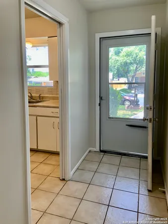 a view of kitchen with granite countertop cabinets and outdoor space