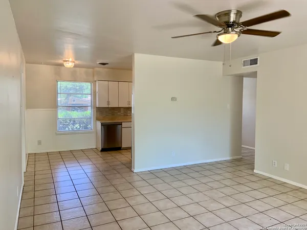 a view of a refrigerator in kitchen and windows