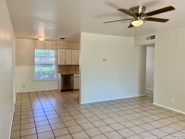 a view of a refrigerator in kitchen and windows