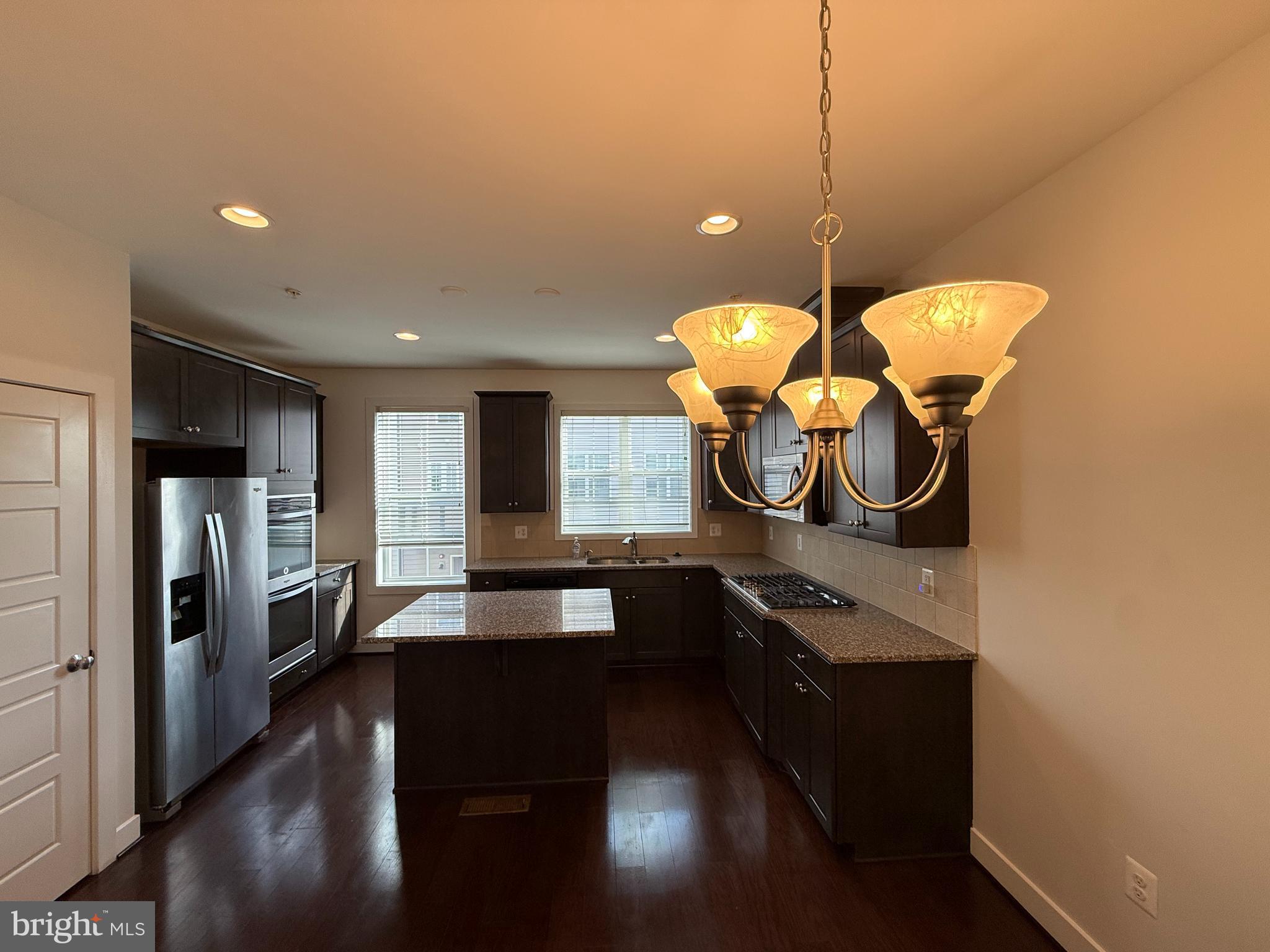 111 Kandinsky Loop Silver Spring, MD 20906 - Photo 5 of 16 a kitchen with stainless steel appliances granite countertop a stove a refrigerator and a microwave