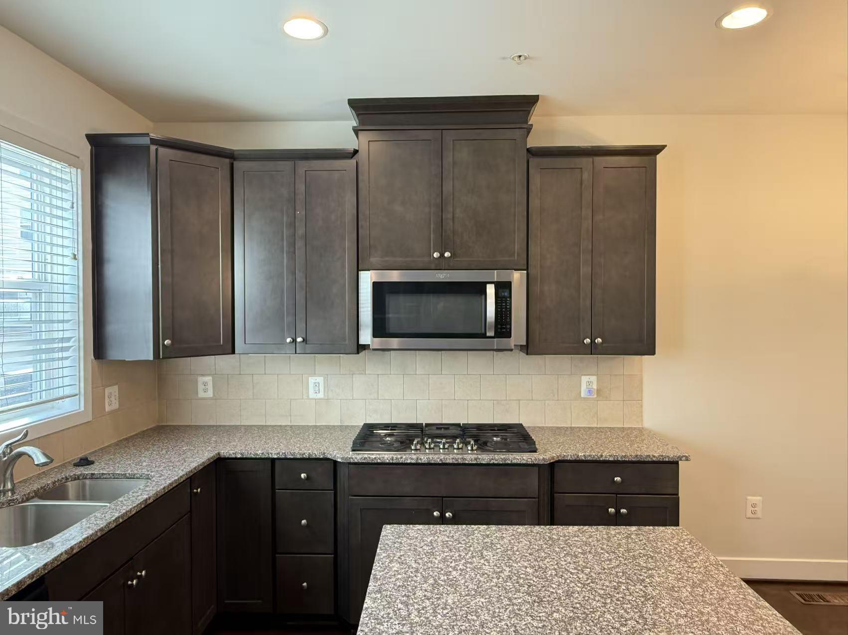 111 Kandinsky Loop Silver Spring, MD 20906 - Photo 6 of 16 a kitchen with a stove and a sink