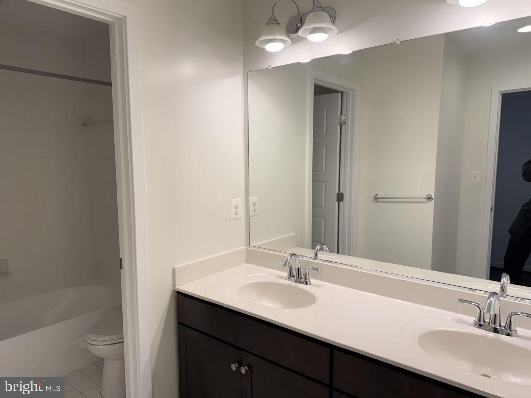 111 Kandinsky Loop Silver Spring, MD 20906 - Photo 9 of 16 a bathroom with a sink a toilet a shower and a mirror