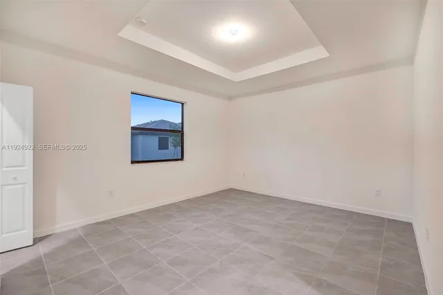 a room with a white cabinets and a refrigerator