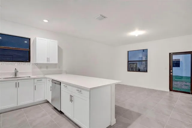 a kitchen with sink cabinets and wooden floor