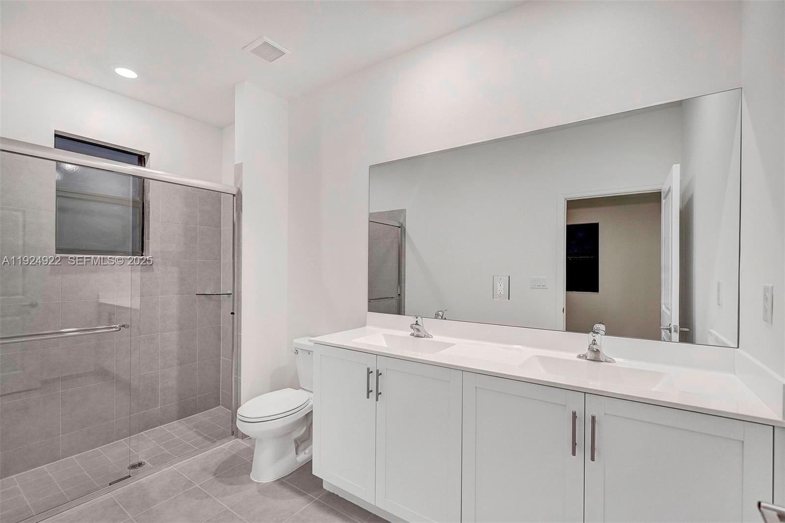 13405 Southwest 285th Street, Unit 13405 Homestead, FL 33033 - Photo 47 of 59 a bathroom with a granite countertop sink a toilet and shower