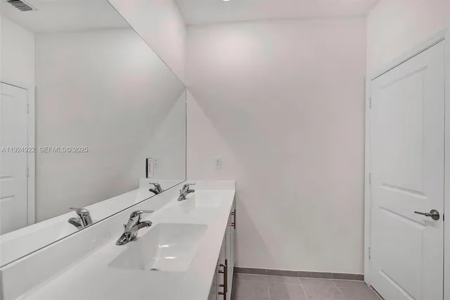 a view of a house with potted plants and a yard